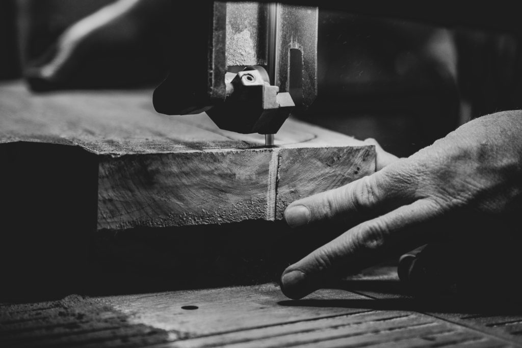 hands sawing wood