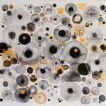 This image depicts a painting of differently sized and patterned circles in hues of black and yellow, and it is reminiscent of looking through a microscope at cells.