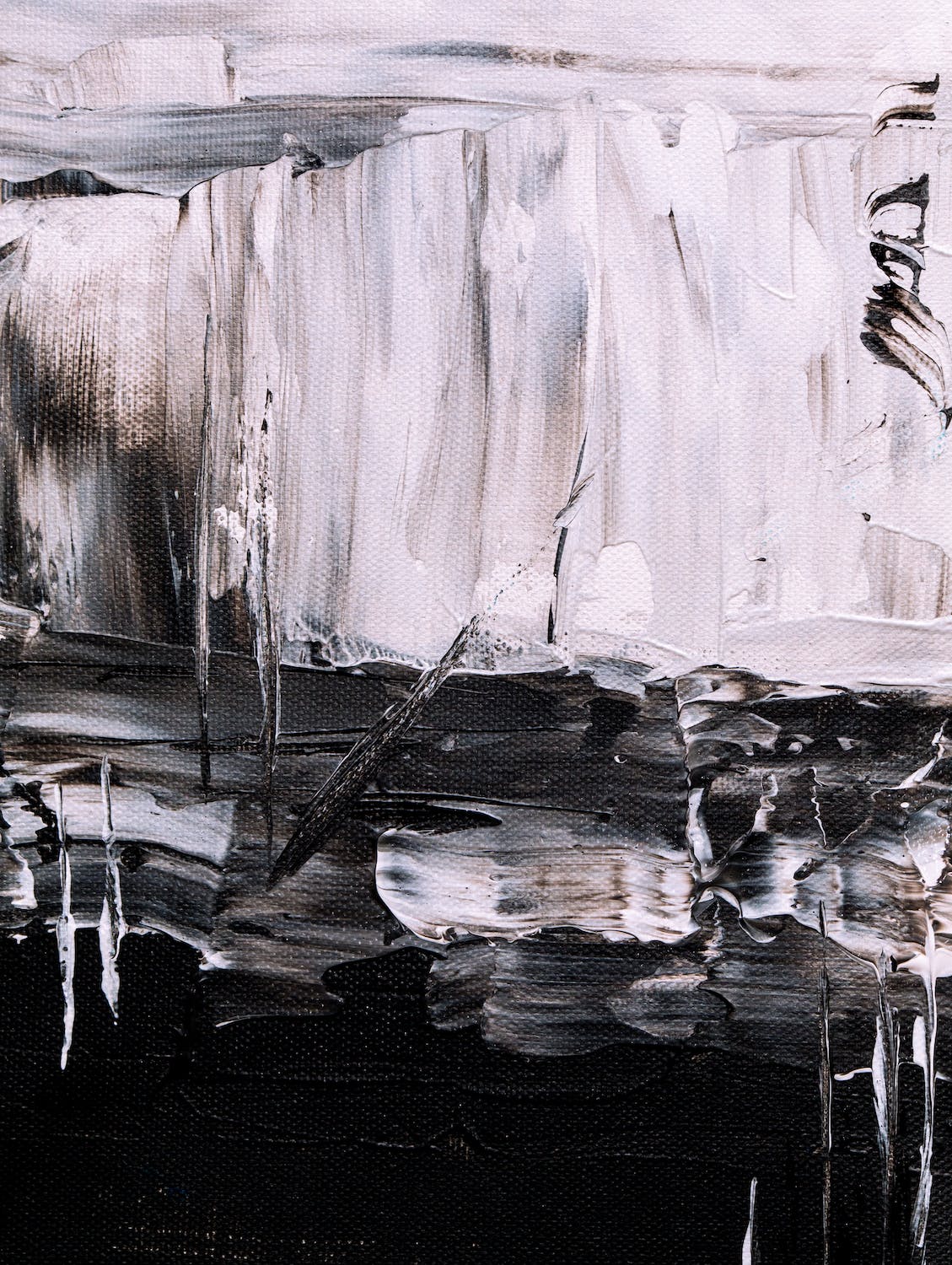 Abstract painting in shades of white and black. White brushstrokes coming down from top. Black brushstrokes across bottom half, starting to mix with white in the middle.