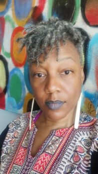 Black woman against background of colorful circles.