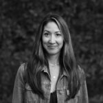 Black and white photo of a woman in a jean jacket