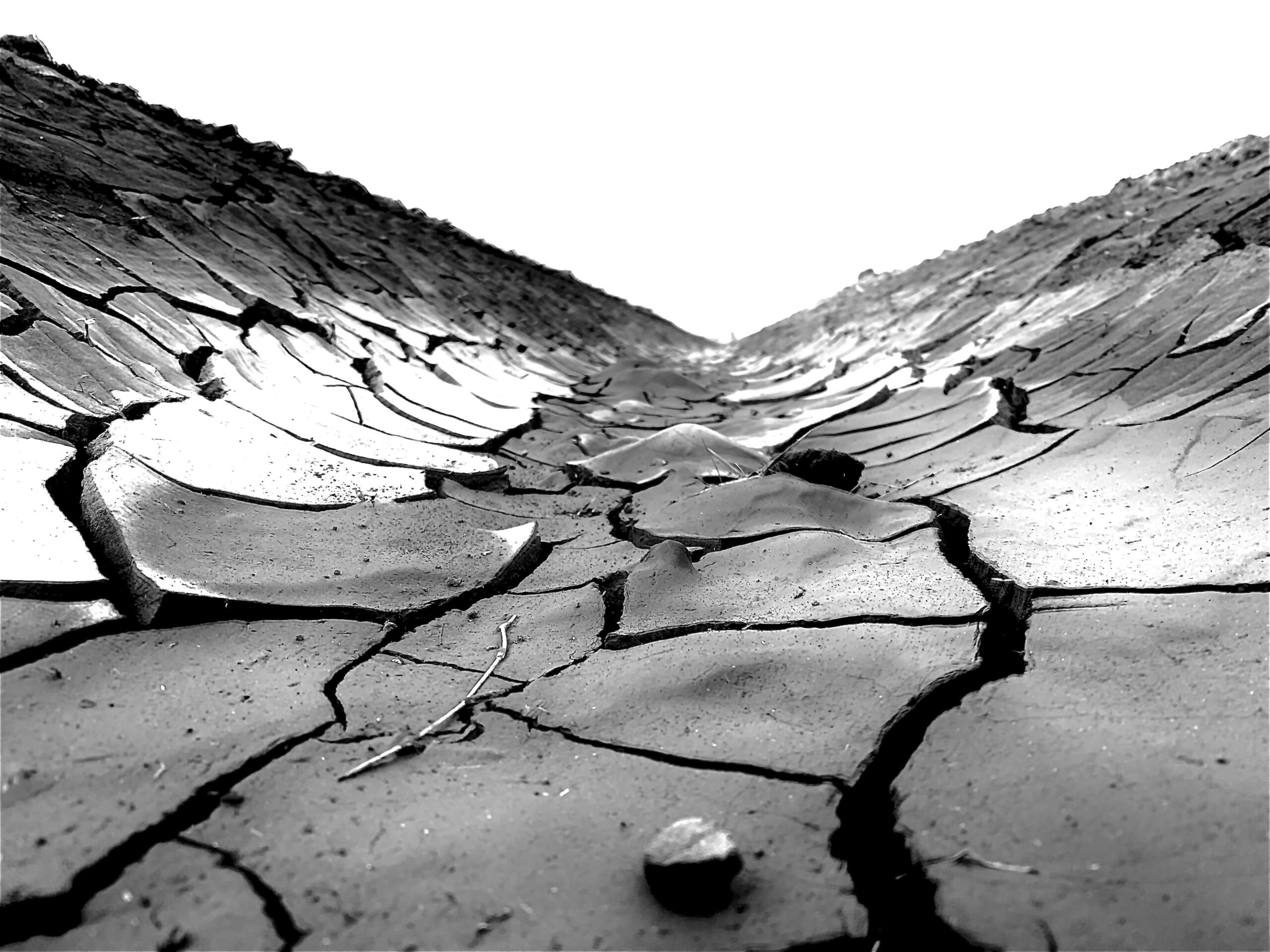 Black and white photo of cracked slabs of earth