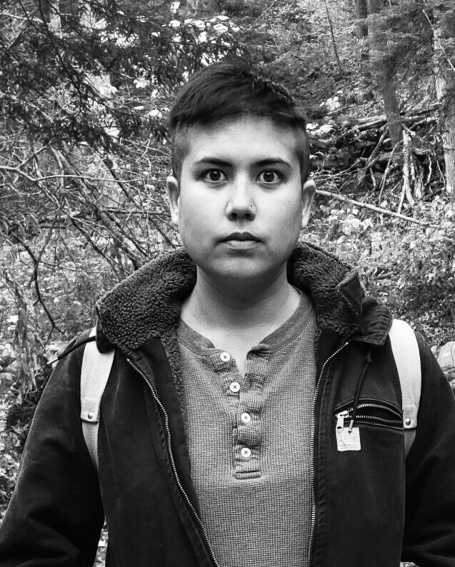 Black and white photo of a person with short dark hair.