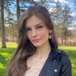 Picture of Mina Victoria, a woman with long brown hair and a black jacket.