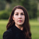 photograph of brunette, white woman wearing a dark shirt
