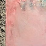 Rose-gold marble-like background, sectioned off from a black pattern on grey background on the left.