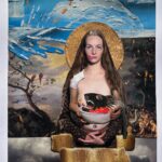 A woman with blue marks on her eyes crosses her hands and holds a bowl with a black lion head. In the background is a paint collage depicting the sea and forest.