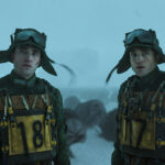 Screencap from Mickey 17 by Bong Joon Ho; picture includes two Robert Pattinsons in military uniform, one with 17 and the other with 18 spray painted on their chests.