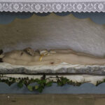 Photo of Jesus Christ laying down in a hollowed out wall