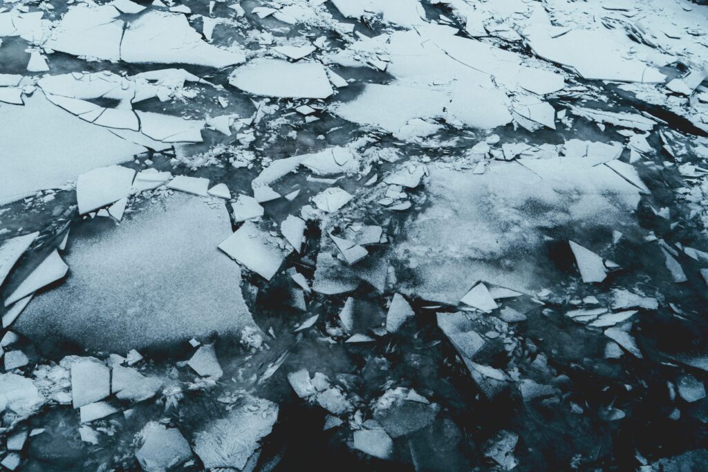 Photo of shattered ice; grey and dark blue tones