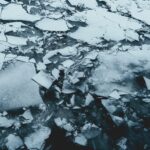 Photo of shattered ice; grey and dark blue tones