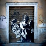 Street art of an angel painted on a roll-up garage door