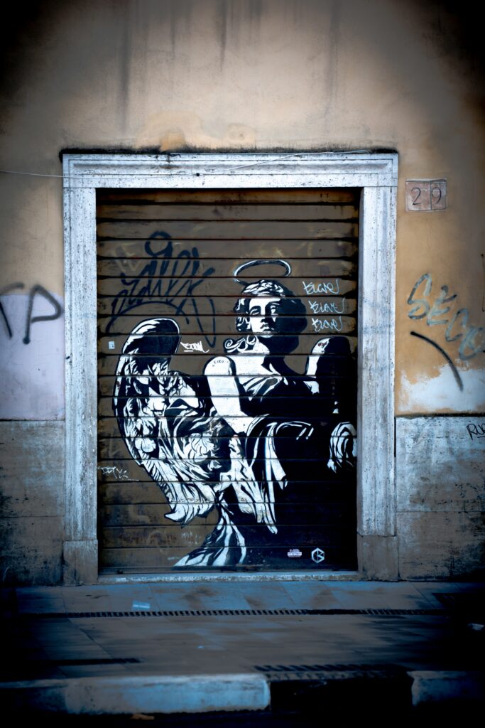 Street art of an angel painted on a roll-up garage door